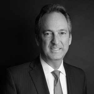 Black and white professional headshot of Justin Sayfie.